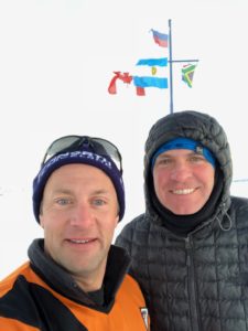 Antarctica Day 1 of the World Marathon Challenge: Brian Winter and Andrew under flags at Nova Station